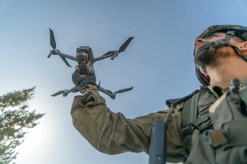 A soldier holding a quadcopter